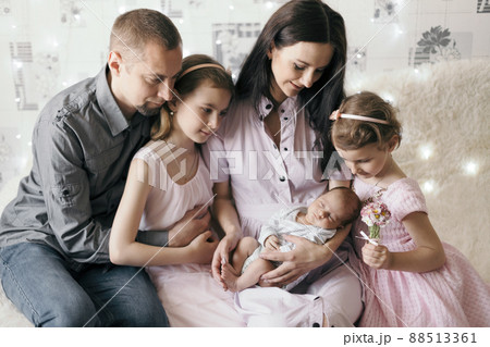 happy married couple with their three children . 88513361