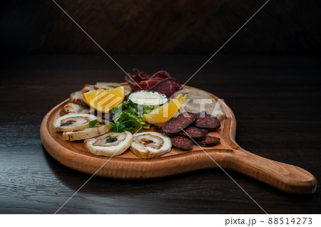 Meat platter on a wooden board in a restaurant of Georgian cuisine. Appetizing snack. 88514273