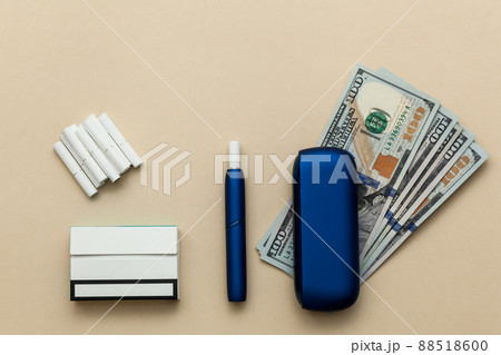 Iqos electronic blue cigarette on a beige background. Iqos electronic blue cigarette on a beige background. 88518600