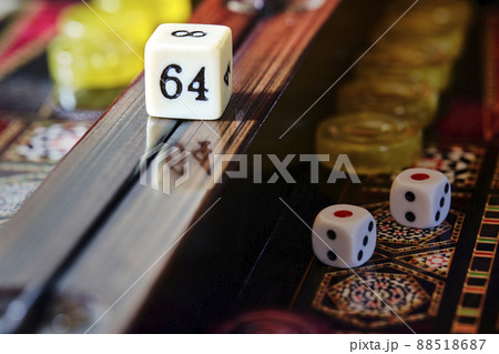Detail of the doubling cube on the center rail of a lacquered backgammon board, macro 88518687
