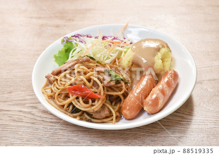 fried spicy spaghetti bacon with pork sausage and mashed potato dressing gravy sauce couple salad on plate fried spicy spaghetti bacon with pork sausage and mashed potato dressing gravy sauce couple salad on plate 88519335