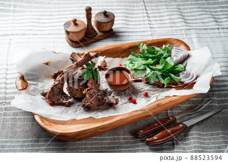 Grilled lamb loin on a wooden plate with wine Grilled lamb loin on a wooden plate with wine 88523594