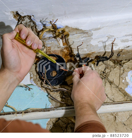 Old electrical wiring in the house, wooden walls in the house, replacement of electrical cables. Old electrical wiring in the house, wooden walls in the house, replacement of electrical cables. 88523720