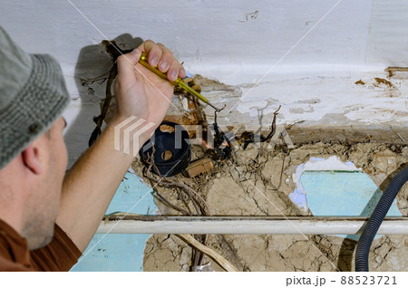 Old electrical wiring in the house, wooden walls in the house, replacement of electrical cables. Old electrical wiring in the house, wooden walls in the house, replacement of electrical cables. 88523721