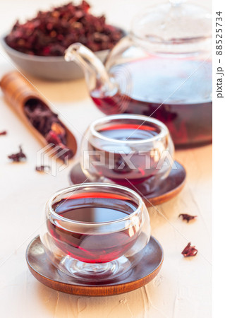 Red tea karkade or hibiscus in glass cups and glass tea pot, vertical Red tea karkade or hibiscus in glass cups and glass tea pot, vertical 88525734