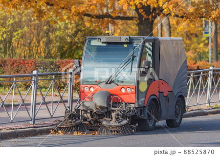 Cleaning machine washes the city street at autumn morning. 88525870