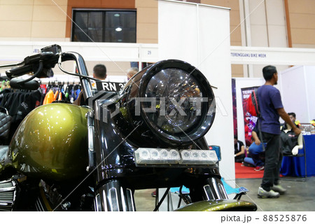 SELANGOR, MALAYSIA - 8 APRIL 2022: Branded motorcycle classic headlights installed on custom motorcycles. The motorcycle was displayed to the public in a large showroom. 88525876