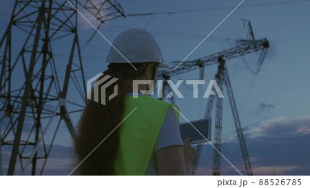 woman power engineer helmet with tablet her hands works. governing body of electricity industry. electrical engineer job concept. young female electrician network repairman. electric tower business. woman power engineer helmet with tablet her hands works. governing body of electricity industry. electrical engineer job concept. young female electrician network repairman. electric tower business. 88526785