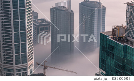 Rare early morning winter fog above the Dubai Marina skyline and skyscrapers rooftops aerial timelapse. Rare early morning winter fog above the Dubai Marina skyline and skyscrapers rooftops aerial timelapse. 88530602