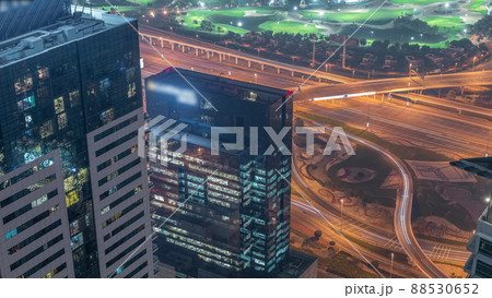 Crossroad junction between golf course and Dubai Marina intersected by Sheikh Zayed Road aerial night timelapse. Crossroad junction between golf course and Dubai Marina intersected by Sheikh Zayed Road aerial night timelapse. 88530652