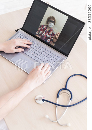 An elderly woman with the flu for an online consultation with a doctor. Female practitioner makes a video call with a patient on a laptop. A pensioner on the remote doctor's office. An elderly woman with the flu for an online consultation with a doctor. Female practitioner makes a video call with a patient on a laptop. A pensioner on the remote doctor's office. 88532000
