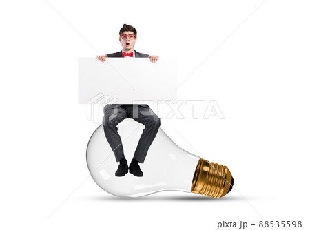 A young businessman sits on a light bulb 88535598