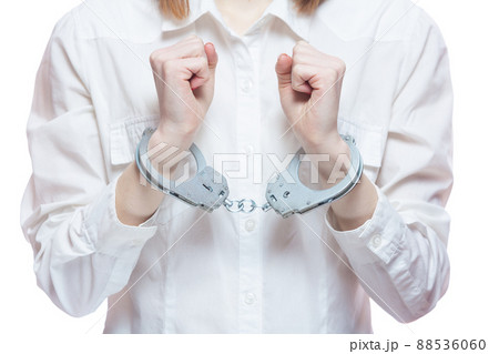 Female hands with handcuffs, on a white background Female hands with handcuffs, on a white background 88536060