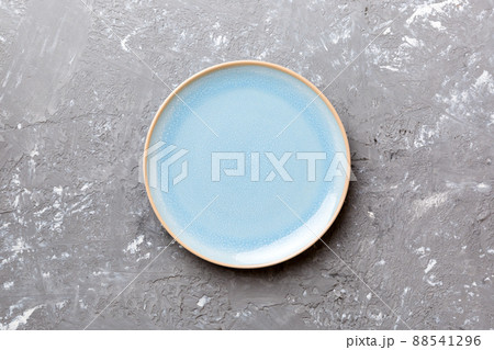 Top view of empty blue plate on cement background. Empty space for your design 88541296