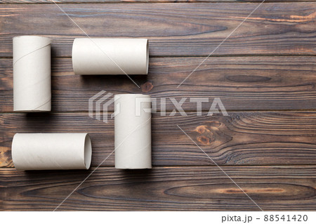 Flat lay composition with empty toilet paper rolls and space for text on color background. Recyclable paper tube with metal plug end made of kraft paper or cardboard Flat lay composition with empty toilet paper rolls and space for text on color background. Recyclable paper tube with metal plug end made of kraft paper or cardboard 88541420