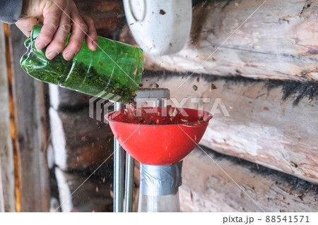 A man blows nuts from small debris using DIY 88541571