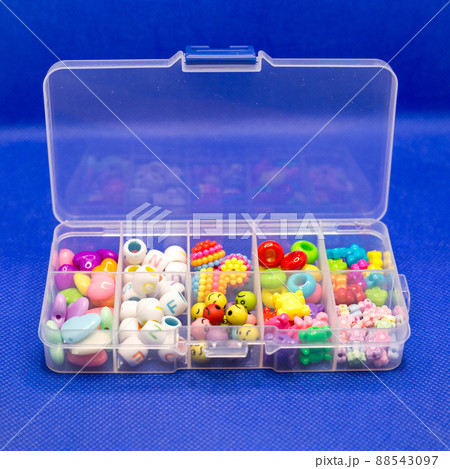 Plastic container with colored round buttons, jewelry for clothes in separate cells 88543097