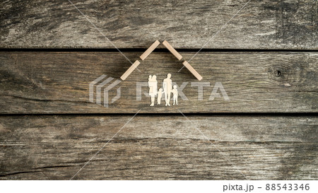 Family home concept with a cut out of a young family with children 88543346