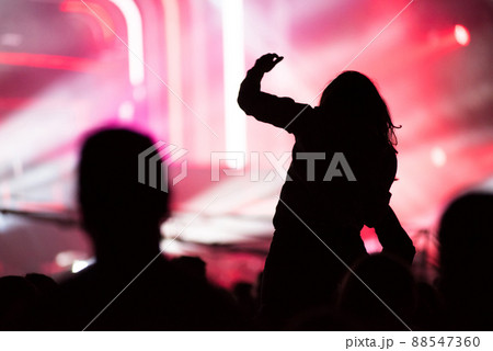 Rear view of crowd with arms outstretched at concert Rear view of crowd with arms outstretched at concert 88547360