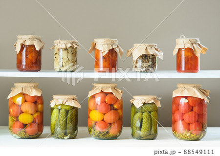 Homemade marinated tomatoes. Canned vegetables in glass jar. 88549111
