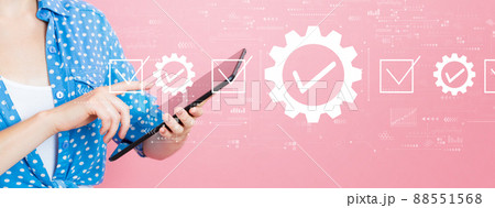 Quality control approval with woman using a tablet Quality control approval with woman using a tablet 88551568