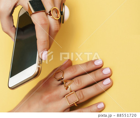 womans hand taking picture of her new manicure with fashion jewelry womans hand taking picture of her new manicure with fashion jewelry 88551720