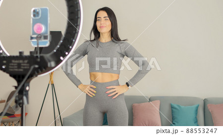 Virtual online fitness. Woman virtual workout at home living room 88553247