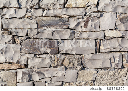 Texture of a stone wall. Old castle stone wall texture background. Texture of a stone wall. Old castle stone wall texture background. 88558892