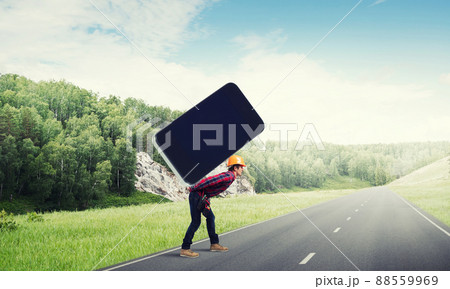 Builder man carry huge smartphone Builder man carry huge smartphone 88559969