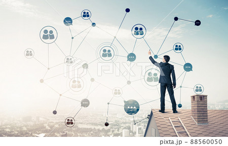 Businessman on house roof presenting networking and connection c 88560050
