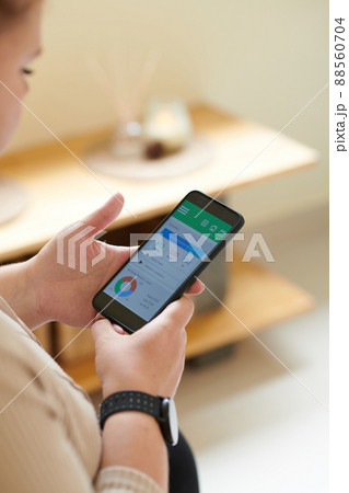 Woman Checking Health App on Smartphone Woman Checking Health App on Smartphone 88560704