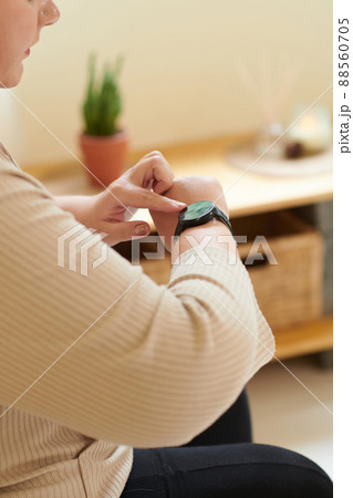 Woman Checking Fitness Tracker 88560705