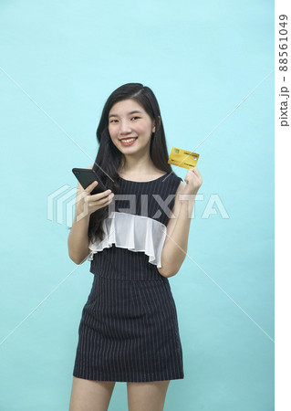 Beautiful Asian woman shopping online Beautiful Asian woman shopping online 88561049