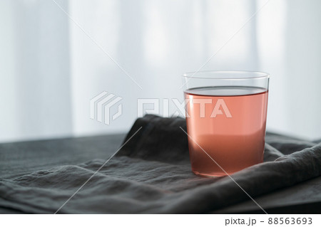 Berry lemonade in tumbler glass on linen cloth Berry lemonade in tumbler glass on linen cloth 88563693