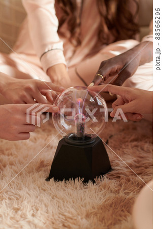 Women Touching Plasma Ball 88566296