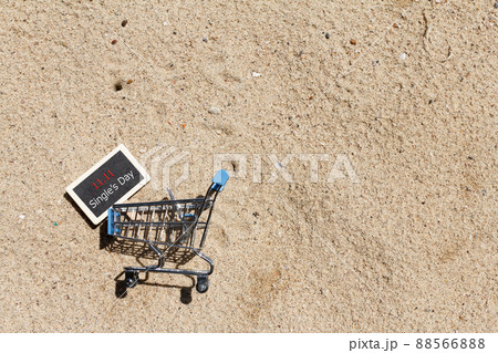 Online shopping of China, 11.11 single's day sale concept. The shopping cart and the text 11.11 single's day sale with sand background. Online shopping of China, 11.11 single's day sale concept. The shopping cart and the text 11.11 single's day sale with sand background. 88566888