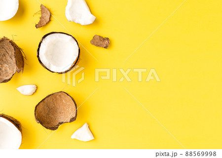 Coconut pieces on yellow background with copyspace. Flat lat. Top view Coconut pieces on yellow background with copyspace. Flat lat. Top view 88569998