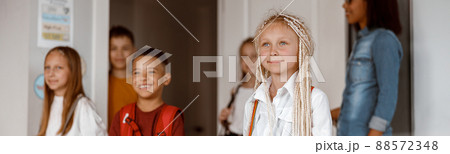 Happy children standing in class at school 88572348