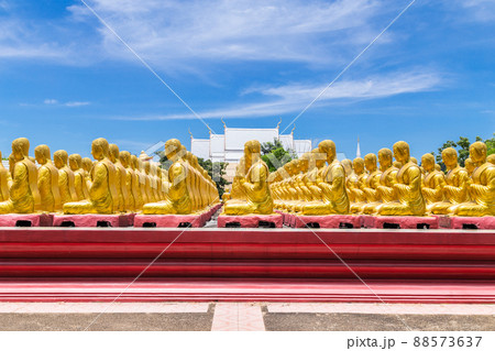 Row of disciple statues surrounding big buddha statue in public to the general public worship worship, Thailand. 88573637