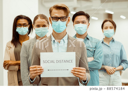 Manager with colleagues in facial covers protect from COVID-19 coronavirus 88574184