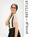 Studio photo of middle aged woman starting getting grey-haired wearing black and white clothes on white background, middle age sexy lady, happy life concept 88575519