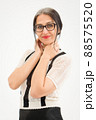 Studio photo of middle aged woman starting getting grey-haired wearing black and white clothes on white background, middle age sexy lady, happy life concept 88575520