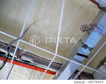SELANGOR, MALAYSIA - MARCH 10, 2022: Polyurethane insulating foam that has been sprayed and covered the surface below the concrete slabs. Serves as a layer of thermal insulation for the building. 88576693
