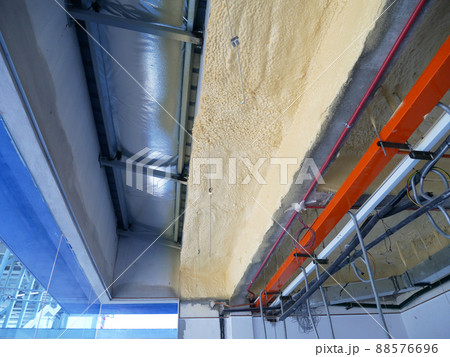 SELANGOR, MALAYSIA - MARCH 10, 2022: Polyurethane insulating foam that has been sprayed and covered the surface below the concrete slabs. Serves as a layer of thermal insulation for the building. SELANGOR, MALAYSIA - MARCH 10, 2022: Polyurethane insulating foam that has been sprayed and covered the surface below the concrete slabs. Serves as a layer of thermal insulation for the building. 88576696