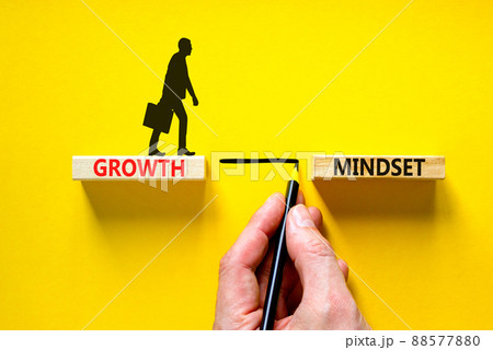 Growth mindset symbol. Wooden blocks with concept words Growth mindset on beautiful yellow background. Businessman icon. Businessman hand. Business growth mindset concept. Copy space. 88577880
