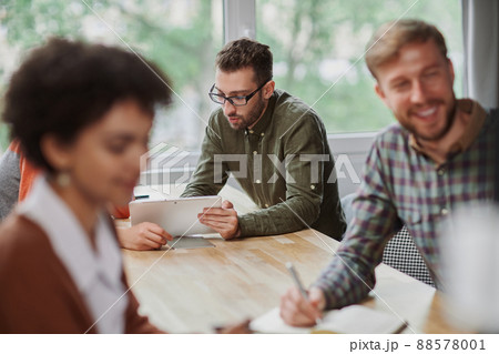 multinational business team using a laptop at a work meeting. 88578001