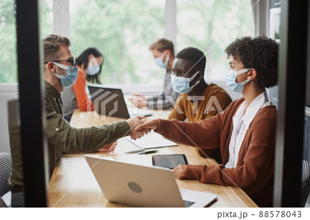 business people in protective masks shaking hands. 88578043