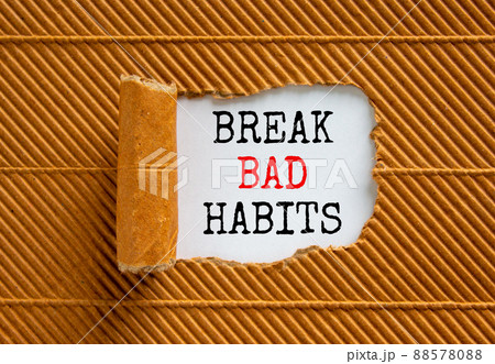 Break bad habits symbol. Words 'Break bad habits' appearing behind torn brown paper. Beautiful brown background. Business, psychology and break bad habits concept, copy space. 88578088