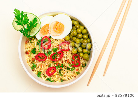 Beautiful Noodle Dish with Green Pea, Eggs, Red Hot Pepper and Greens Beautiful Noodle Dish with Green Pea, Eggs, Red Hot Pepper and Greens 88579100