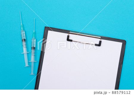 Vaccination or Revaccination Concept - Two Medical Syringe on Blue Table 88579112